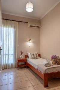 a bedroom with two beds and a window at Filoxenia Apartments in Mytilene