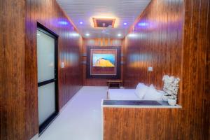 a room with wood paneled walls and a couch at Sunny Villa Entire With Pool in Udaipur