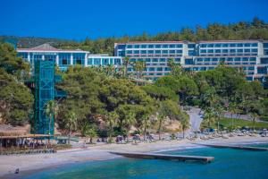a view of a resort with a beach and buildings at Pine Bay Holiday Resort in Kusadası