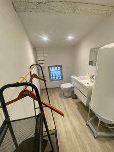 a room with a bathroom with a sink and a toilet at Superbe Appartement Atypique Combles - Neuf avec Vue in Narbonne