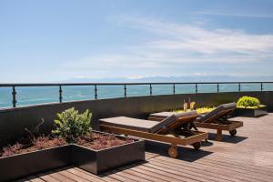 a deck with two lounge chairs and the ocean at Voyage Belek Golf & Spa Hotel in Belek
