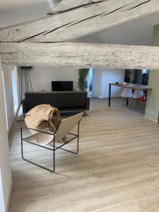 a living room with a couch and a chair at Superbe Appartement Atypique Combles - Neuf avec Vue in Narbonne +9 photos