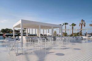 a group of chairs and tables in a pavilion at Voyage Belek Golf & Spa Hotel in Belek