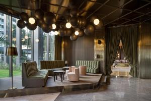 a lobby with couches and a table and balloons at Voyage Belek Golf & Spa Hotel in Belek
