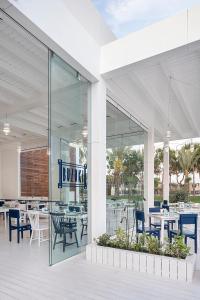 a restaurant with tables and chairs in a building at Voyage Belek Golf & Spa Hotel in Belek