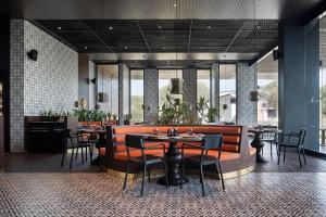 a restaurant with tables and chairs in a room at Voyage Belek Golf & Spa Hotel in Belek