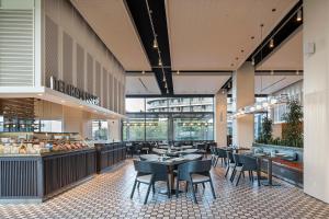 a restaurant with tables and chairs and a cafeteria at Voyage Belek Golf & Spa Hotel in Belek