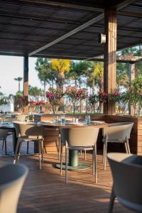 a row of tables and chairs in a restaurant at Voyage Belek Golf & Spa Hotel in Belek