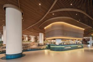 a lobby of a building with a restaurant at Voyage Belek Golf & Spa Hotel in Belek