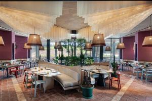 a restaurant with tables and chairs in a room at Voyage Belek Golf & Spa Hotel in Belek