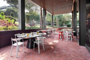 a restaurant with tables and chairs on a patio at Voyage Belek Golf & Spa Hotel in Belek