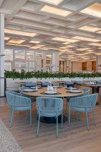 a dining room with tables and chairs and ceilings at Voyage Torba Hotel in Torba