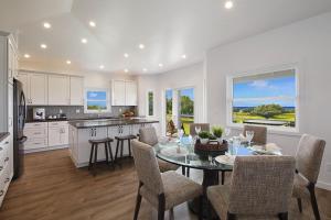 a kitchen and dining room with a table and chairs at Haupu Hale at Poipu in Koloa
