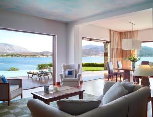 ein Wohnzimmer mit Blick aufs Wasser in der Unterkunft Grand Resort Lagonissi in Lagonisi