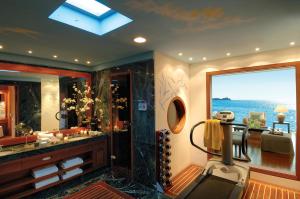 a bathroom with a shower with a view of the ocean at Grand Resort Lagonissi in Lagonissi