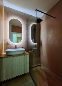 a bathroom with a sink and a mirror at Apartmán s pekným výhľadom in Rimavská Sobota