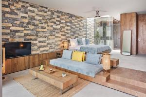a bedroom with a king sized bed and a tv at Voyage Torba Hotel in Torba
