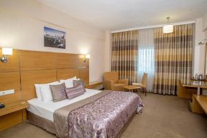 a hotel room with a bed and a desk at Grand Cali Hotel in Bozuyuk +54 photos