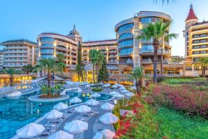 a resort with a pool in front of buildings at Arycanda Kirman Premium - Ultra All Inclusive in Okurcalar