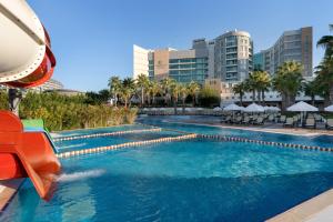 a swimming pool with a slide in a city at Sherwood Exclusive Lara in Lara