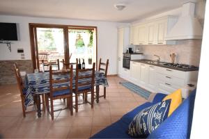 a kitchen and dining room with a table and chairs at Villa Giada in Domus de Maria +37 photos
