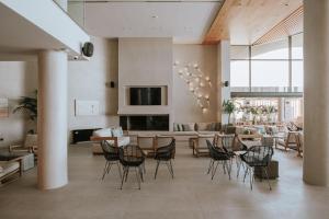 a lobby with chairs and a living room at Unique Blue! Resort and Villas Adults Only in Karteros