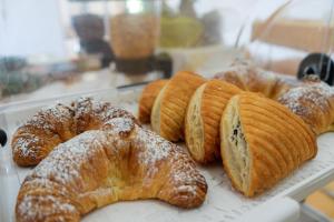 a bunch of croissants and other pastries on a tray at Tenuta San Lorenzo in Otranto +47 photos