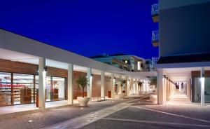 a row of buildings at night with potted plants at Verudela Villas in Pula