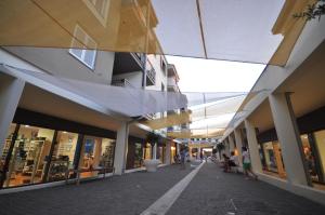a shopping mall with people walking down a street at Verudela Villas in Pula