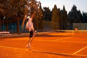 two people playing tennis on a tennis court at Verudela Villas in Pula +22 photos