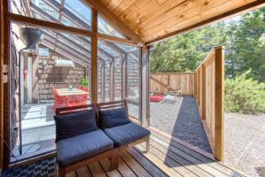 a screened in porch with a couch on a deck at Blue Heron - Modern Chef Kitchen, Hot Tub near Beach in Seaside +57 photos