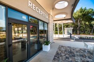 a building with the entrance to a restaurant at Arena Grand Kazela Camping Homes in Medulin