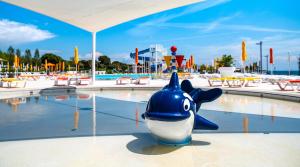 a water park with a shark toy in the water at Arena Grand Kazela Camping Homes in Medulin