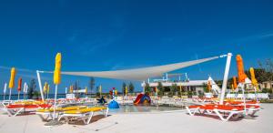 a group of boats parked next to a pool at Arena Grand Kazela Camping Homes in Medulin