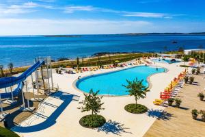 an overhead view of a swimming pool and the ocean at Arena Grand Kazela Camping Homes in Medulin