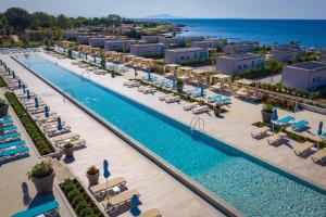an aerial view of a resort pool with lounge chairs and the ocean at Arena Grand Kazela Camping Homes in Medulin