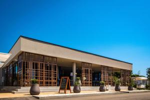 a building with potted plants in front of it at Arena Grand Kazela Camping Homes in Medulin