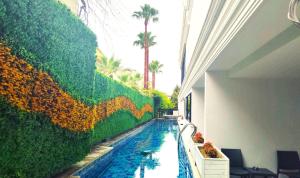 a swimming pool with a mural of a sunflower wall at Side Zeugma Hotel - Adult Only 16 Plus in Side