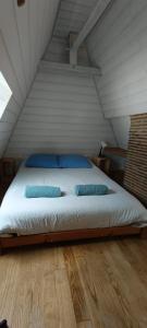 a bed in a attic with two pillows on it at Suite Duplex Vientiane - Second Lodge - Hyper Centre Historique Rennes - 2 personnes in Rennes