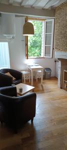 a living room with a couch and a table at Suite Duplex Vientiane - Second Lodge - Hyper Centre Historique Rennes - 2 personnes in Rennes