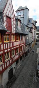 a group of buildings with red and white windows at Suite Duplex Vientiane - Second Lodge - Hyper Centre Historique Rennes - 2 personnes in Rennes