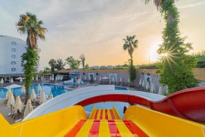 a pool with a slide at a resort at Q Ella Beach Hotel in Side