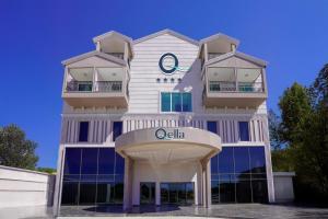 a building with a clock on top of it at Q Ella Beach Hotel in Side