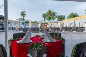 a table with a red table cloth and white sails at Q Ella Beach Hotel in Side