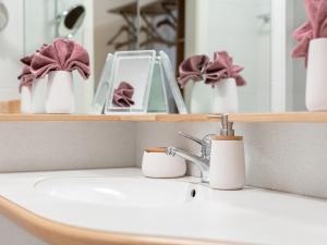 a sink in a bathroom with a mirror and a sink at Valerie in Kitzbühel +22 photos