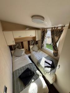 two beds in the back of a camper van at Moselle - 6 Squirrel View in Ballantrae