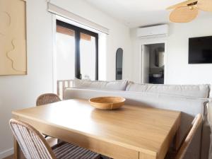 a living room with a wooden table and a couch at Retiro do Gerês in Geres