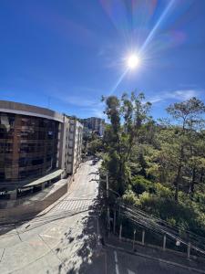a view of a building with the sun in the sky at the 5th floor in Baguio