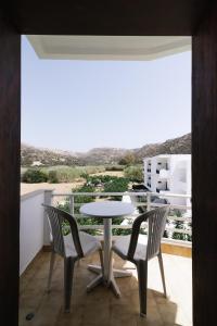 a table and chairs on a balcony with a view at Elea Terra Hotel in Matala