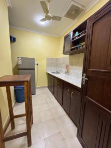 a kitchen with a sink and a refrigerator at Sweet dream house in Zanzibar City